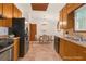 Open kitchen offers hardwood-style floors, modern appliances, and a view into the staged dining area at 2419 Anderson Mill Rd, Austell, GA 30106