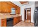 The kitchen features classic cabinets, a black refrigerator, and is bathed in natural light at 2419 Anderson Mill Rd, Austell, GA 30106