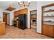 View of the kitchen from the hallway leading into the staged living room with stone fireplace at 2419 Anderson Mill Rd, Austell, GA 30106