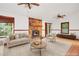 Neutral staged living room showcases stone fireplace, hardwood-style floors, and comfortable seating at 2419 Anderson Mill Rd, Austell, GA 30106