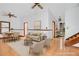Bright, staged living room with hardwood-style floors, dining area, neutral furniture, and stairs at 2419 Anderson Mill Rd, Austell, GA 30106