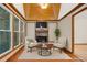 Inviting sun room with fireplace, wood-paneled ceiling, and plenty of natural light at 2419 Anderson Mill Rd, Austell, GA 30106