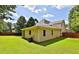 Inviting backyard with a spacious lawn, manicured landscaping, and a screened porch at 3520 Mystic Dr, Buford, GA 30519