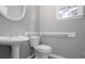Powder room features a modern pedestal sink, toilet, and accent mirror at 3520 Mystic Dr, Buford, GA 30519