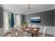 Cozy dining room with wood floors, white wainscoting, and natural light from the bay window at 3520 Mystic Dr, Buford, GA 30519