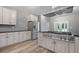 Spacious kitchen featuring stainless steel appliances, white cabinetry, and modern fixtures at 3520 Mystic Dr, Buford, GA 30519
