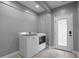 Bright laundry room with a side-by-side washer and dryer set and access door at 3520 Mystic Dr, Buford, GA 30519