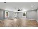 Open living room boasts recessed lights, ceiling fan and multiple windows at 3520 Mystic Dr, Buford, GA 30519