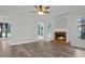 Cozy living room showcasing a fireplace with brick hearth and wood floors at 3520 Mystic Dr, Buford, GA 30519