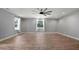 Bright living room features wood floors, multiple windows, ceiling fan and recessed lights at 3520 Mystic Dr, Buford, GA 30519
