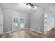 Bright living room features neutral walls, wood floors and double doors leading to outdoor space at 3520 Mystic Dr, Buford, GA 30519