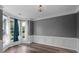 Bright living room with bay window, hardwood floors, and elegant trim details throughout at 3520 Mystic Dr, Buford, GA 30519