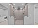 Large walk-in shower with dual shower heads and seating, conveniently near laundry at 3520 Mystic Dr, Buford, GA 30519