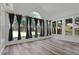 Inviting sun room with multiple windows, curtains and hardwood floors at 3520 Mystic Dr, Buford, GA 30519