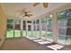 Relaxing sunroom with floor-to-ceiling windows and a ceiling fan at 3520 Mystic Dr, Buford, GA 30519