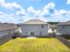 Large grassy backyard with a wood privacy fence and sliding glass doors to the house at 3660 Cattle Field Xing, Loganville, GA 30052
