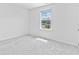 Bedroom featuring large window with neighborhood views and plush carpeting at 3660 Cattle Field Xing, Loganville, GA 30052