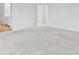 Spacious bedroom with neutral carpet and adjacent bathroom entrance at 3660 Cattle Field Xing, Loganville, GA 30052
