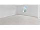 Bright bedroom with neutral carpet features a large window providing natural light at 3660 Cattle Field Xing, Loganville, GA 30052