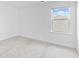 Bright bedroom featuring neutral carpeting, a large window and fresh, white paint at 3660 Cattle Field Xing, Loganville, GA 30052