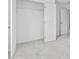 Bedroom with closet featuring double doors with shelving, neutral carpeting, and neutral walls at 3660 Cattle Field Xing, Loganville, GA 30052