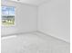 Bedroom featuring a large window offering neighborhood views, neutral carpeting, and neutral walls at 3660 Cattle Field Xing, Loganville, GA 30052
