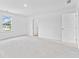 Bright bedroom features a large window and doorway with white trim and doors at 3660 Cattle Field Xing, Loganville, GA 30052