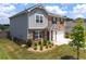 Side view of a two-story home with vinyl siding, landscaping, and a two-car attached garage at 3660 Cattle Field Xing, Loganville, GA 30052