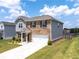 View of a two story brick home showing the driveway and an attached two-car garage at 3660 Cattle Field Xing, Loganville, GA 30052