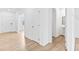Hallway featuring hardwood floors, neutral walls, and access to the main floor at 3660 Cattle Field Xing, Loganville, GA 30052