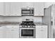 Close up of a kitchen with stainless steel appliances and granite countertops at 3660 Cattle Field Xing, Loganville, GA 30052