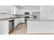 Modern kitchen featuring stainless steel appliances, granite countertops, and white cabinetry at 3660 Cattle Field Xing, Loganville, GA 30052