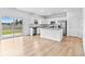Bright living room area with kitchen featuring granite countertops and stainless steel appliances at 3660 Cattle Field Xing, Loganville, GA 30052