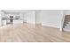 Open concept living room with hardwood floors, a view of the kitchen, and access to the stairs at 3660 Cattle Field Xing, Loganville, GA 30052
