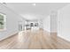 Bright, open-concept living space with light wood floors and a modern kitchen at 3660 Cattle Field Xing, Loganville, GA 30052