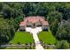 Aerial view of a luxury estate featuring a large lawn and extensively landscaped grounds at 720 Heards Ferry Rd, Sandy Springs, GA 30328