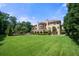 Large backyard of Mediterranean home with well manicured lawn and mature trees at 720 Heards Ferry Rd, Sandy Springs, GA 30328