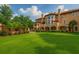 Lush backyard with manicured lawn and a covered patio for elegant outdoor entertaining at 720 Heards Ferry Rd, Sandy Springs, GA 30328