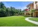 Large backyard of Mediterranean home with well manicured lawn and mature trees at 720 Heards Ferry Rd, Sandy Springs, GA 30328