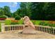 Sculpted lion statue in backyard with lush landscaping, stone walls, and flowering plants at 720 Heards Ferry Rd, Sandy Springs, GA 30328