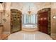 Lavish bathroom with jacuzzi tub, marble tile, decorative ceiling, and glass shower at 720 Heards Ferry Rd, Sandy Springs, GA 30328