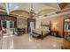 Primary bedroom featuring a tray ceiling, luxurious fabrics, fireplace, and private access to the balcony at 720 Heards Ferry Rd, Sandy Springs, GA 30328