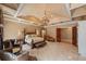 Cozy main bedroom boasts a tray ceiling, sitting area, fireplace and neutral tones ideal for relaxing and sleeping at 720 Heards Ferry Rd, Sandy Springs, GA 30328