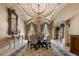 Formal dining room with a decorative ceiling, chandelier, and sophisticated furnishings at 720 Heards Ferry Rd, Sandy Springs, GA 30328