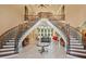 Elegant foyer featuring a dual staircase, marble floors, and soaring ceilings at 720 Heards Ferry Rd, Sandy Springs, GA 30328