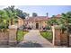 Elegant Mediterranean-style estate with wrought iron gate and lush landscaping at 720 Heards Ferry Rd, Sandy Springs, GA 30328