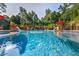 Beautiful pool with water features, stylish outdoor furniture, and lush greenery at 720 Heards Ferry Rd, Sandy Springs, GA 30328