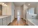 Bathroom showcasing a granite double vanity, shower, and bathtub at 1816 Kingsmere Run Dr, Loganville, GA 30052