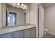 Modern bathroom featuring double vanity with granite countertop and gray cabinets at 1816 Kingsmere Run Dr, Loganville, GA 30052