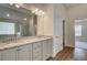 Bathroom featuring a double vanity with granite counters and modern lighting at 1816 Kingsmere Run Dr, Loganville, GA 30052